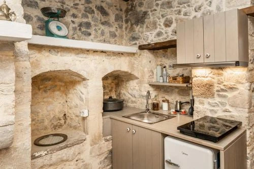 Traditional white-washed Greek villa vacation rental surrounded by olive trees