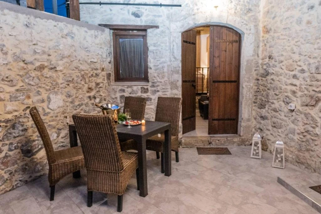 Traditional white-washed Greek villa vacation rental surrounded by olive trees